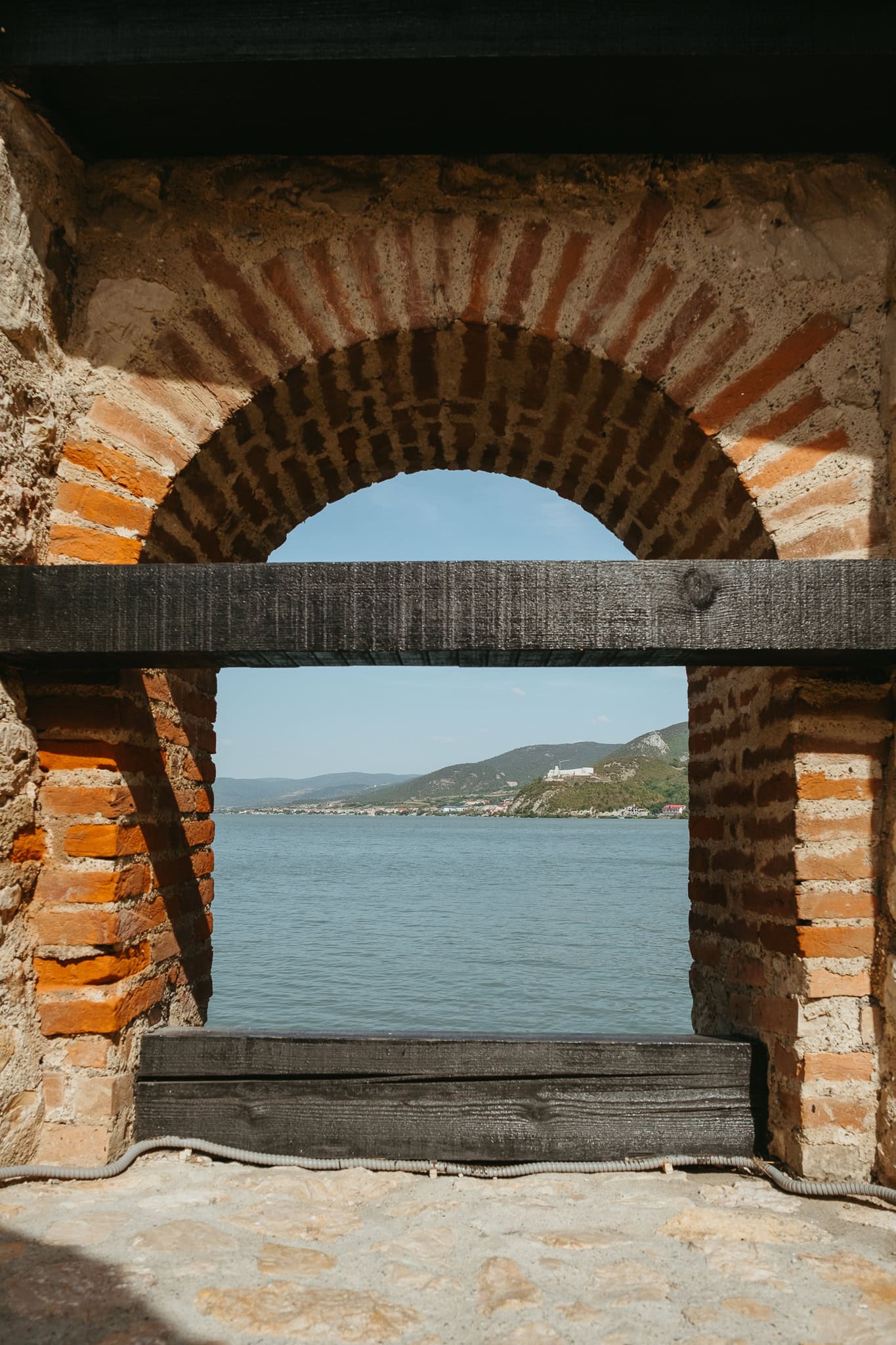 Looking through an open arch in a fortress.